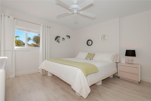 bedroom with ceiling fan and light hardwood / wood-style flooring