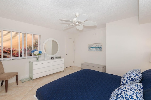 tiled bedroom featuring a textured ceiling and ceiling fan