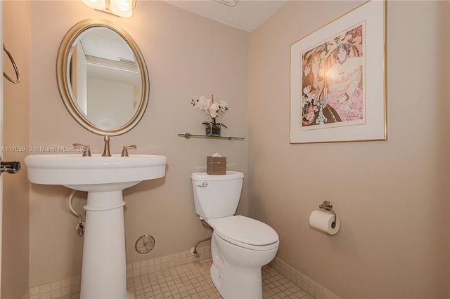 bathroom with tile patterned floors and toilet