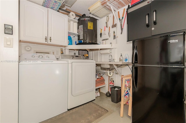 clothes washing area with cabinets, separate washer and dryer, sink, and water heater