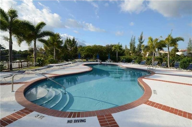 view of swimming pool with a patio area