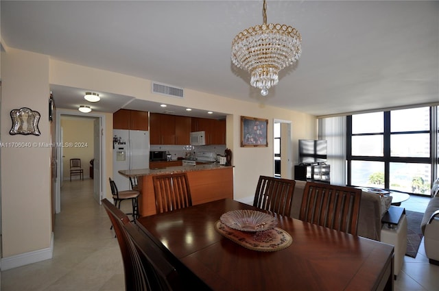 dining area featuring an inviting chandelier