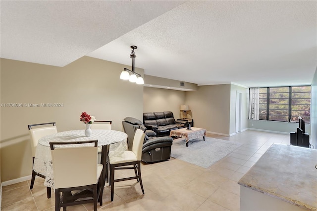 tiled dining area with a textured ceiling