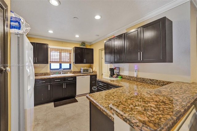 kitchen featuring white appliances, sink, ornamental molding, light stone counters, and kitchen peninsula