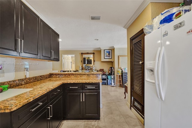 kitchen with a textured ceiling, kitchen peninsula, white refrigerator with ice dispenser, and ornamental molding