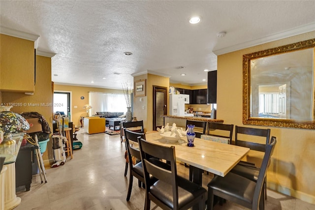 dining area with crown molding and a textured ceiling