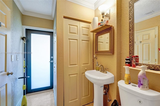 bathroom featuring crown molding, tile patterned flooring, a textured ceiling, and toilet