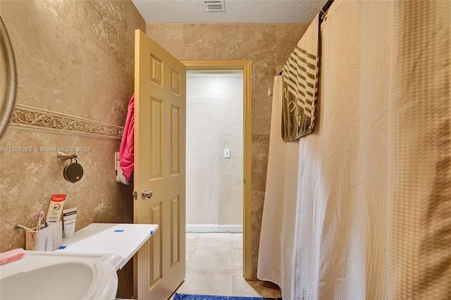 bathroom with a textured ceiling