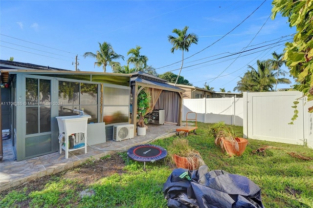 view of yard with ac unit and a patio area