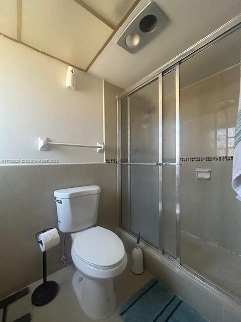 bathroom featuring toilet and walk in shower