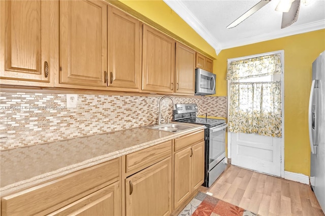 kitchen featuring sink, backsplash, crown molding, light hardwood / wood-style floors, and appliances with stainless steel finishes