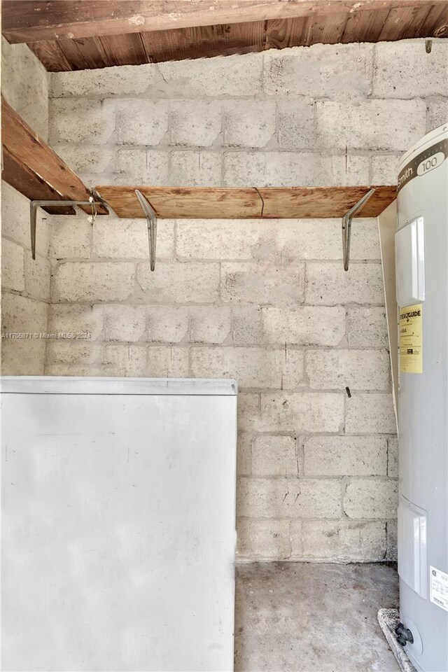 interior space with water heater and concrete floors