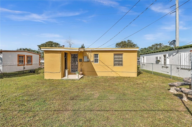 back of property with a yard