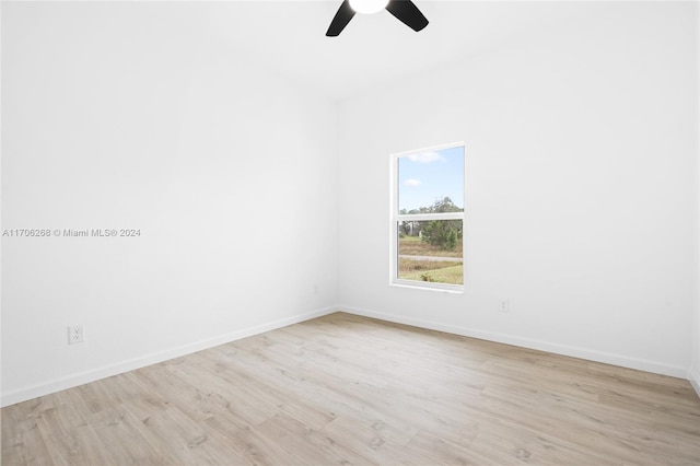 spare room with ceiling fan and light wood-type flooring