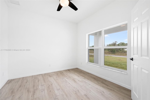 empty room featuring ceiling fan and light hardwood / wood-style floors