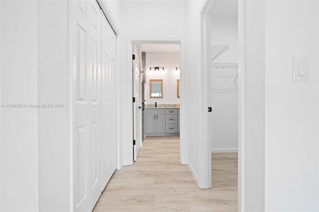 hallway featuring sink and light hardwood / wood-style flooring