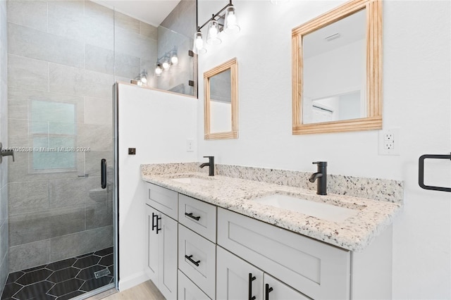 bathroom with vanity and a shower with door