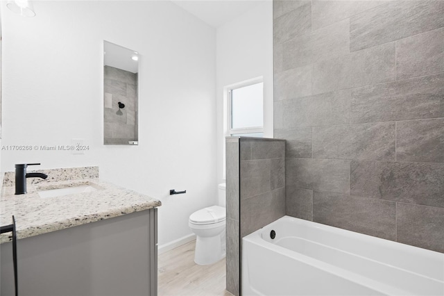 bathroom with hardwood / wood-style flooring, vanity, and toilet