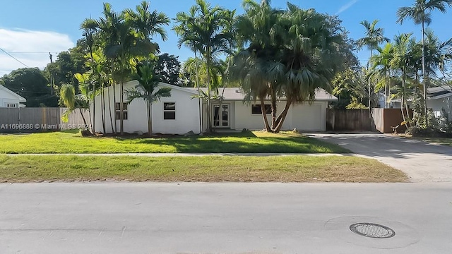 view of front of house with a front yard and a garage