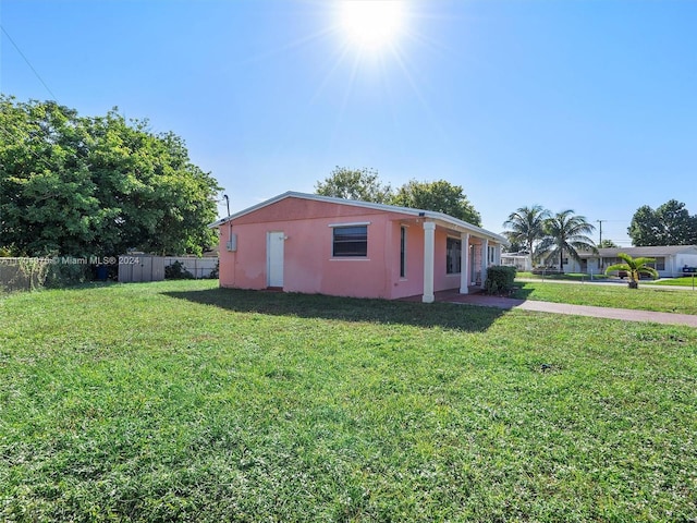 view of home's exterior with a storage shed and a yard