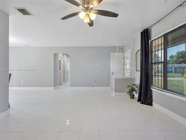 spare room with light tile patterned floors and ceiling fan