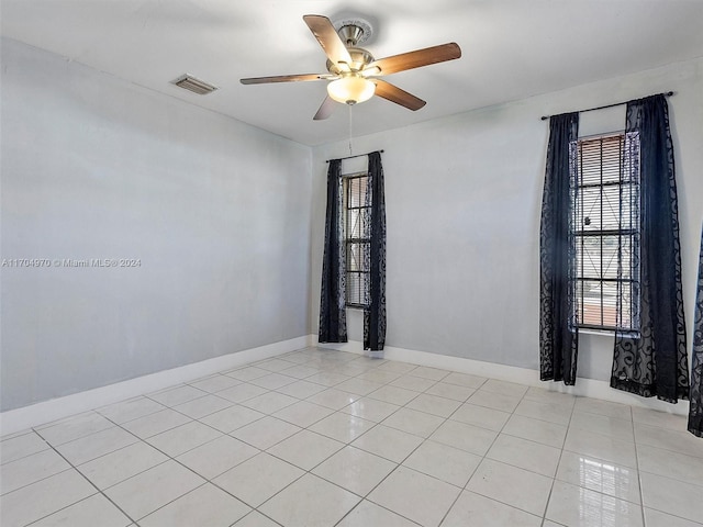 tiled empty room with ceiling fan