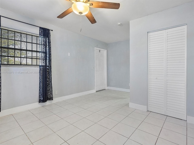 unfurnished room featuring ceiling fan and light tile patterned floors