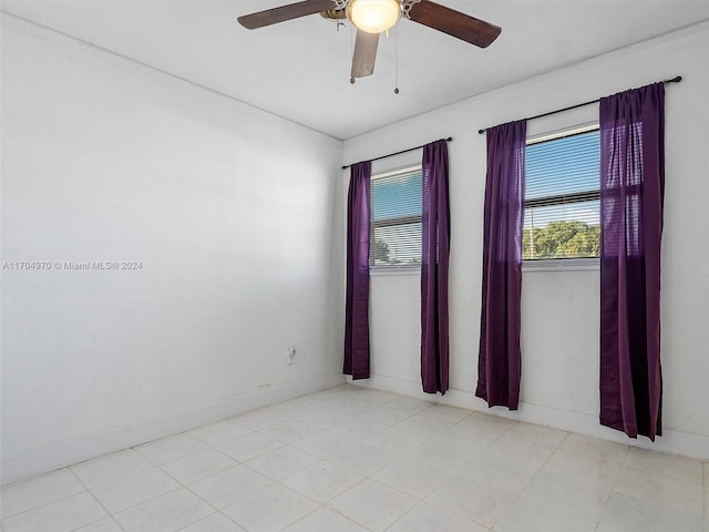 unfurnished room with ceiling fan and crown molding