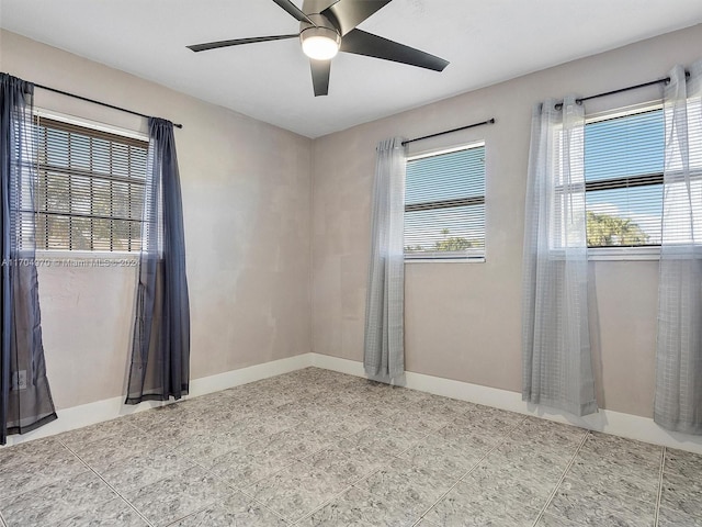 unfurnished room with a wealth of natural light and ceiling fan