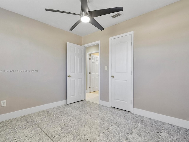 unfurnished bedroom featuring ceiling fan