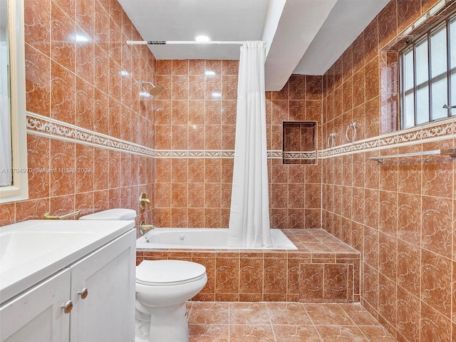 full bathroom with vanity, tile patterned floors, toilet, shower / bathtub combination with curtain, and tile walls