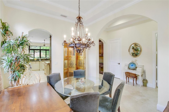 dining area featuring ceiling fan with notable chandelier and ornamental molding