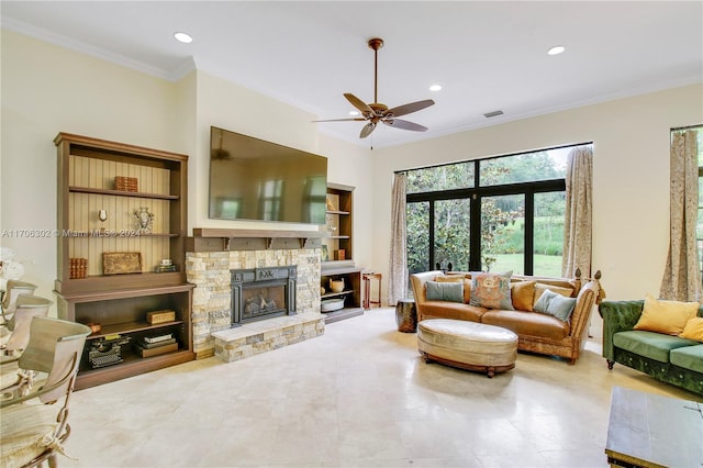 living room with ceiling fan, a fireplace, and crown molding