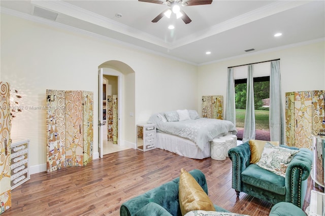 bedroom with ceiling fan, crown molding, and hardwood / wood-style flooring