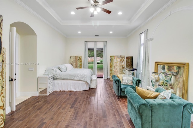 bedroom with access to exterior, dark hardwood / wood-style flooring, ornamental molding, a raised ceiling, and ceiling fan