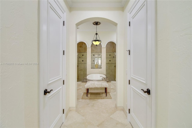 corridor featuring ornamental molding and light tile patterned floors