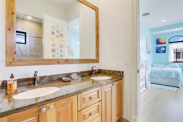 bathroom with hardwood / wood-style floors, vanity, and plenty of natural light