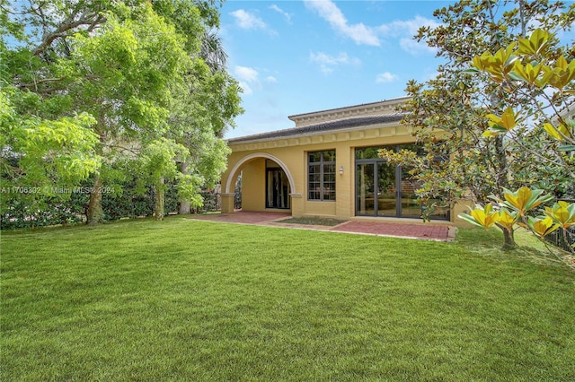 back of house with a yard