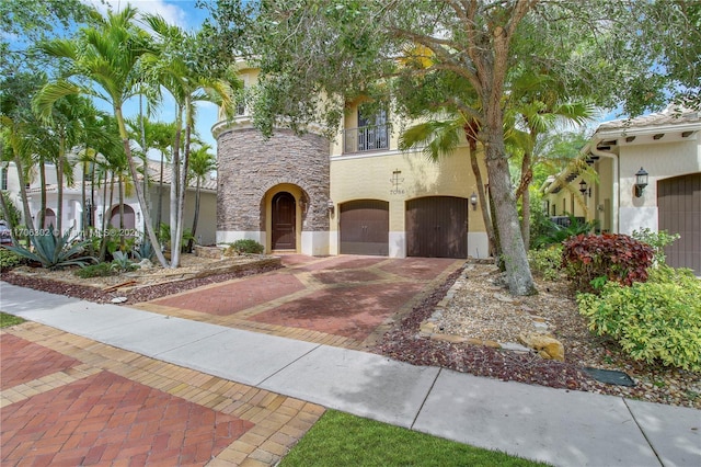 mediterranean / spanish-style home with a balcony and a garage