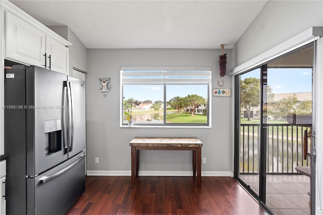 kitchen featuring white cabinetry, stainless steel fridge with ice dispenser, a textured ceiling, and dark hardwood / wood-style floors