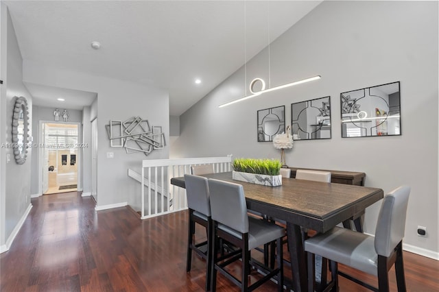 dining area with dark wood-type flooring and high vaulted ceiling