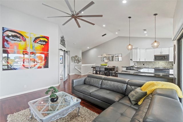 living room featuring ceiling fan, lofted ceiling, and dark wood-type flooring