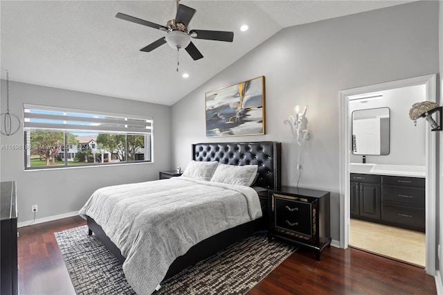 bedroom featuring connected bathroom, ceiling fan, dark hardwood / wood-style flooring, and vaulted ceiling