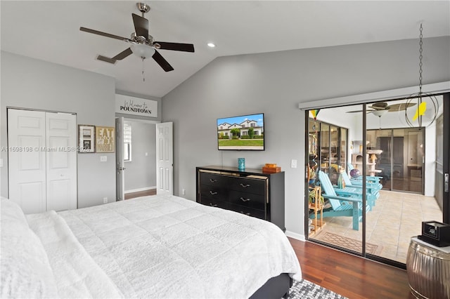 bedroom with access to exterior, ceiling fan, dark hardwood / wood-style flooring, vaulted ceiling, and multiple windows