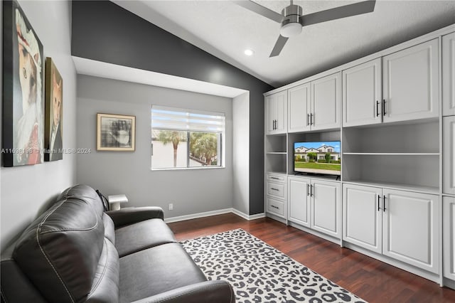 living room featuring a textured ceiling, dark wood-type flooring, ceiling fan, and lofted ceiling