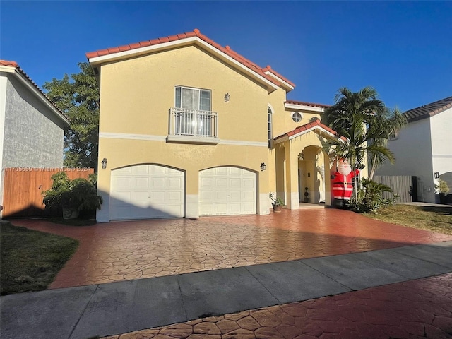 mediterranean / spanish-style home with a garage