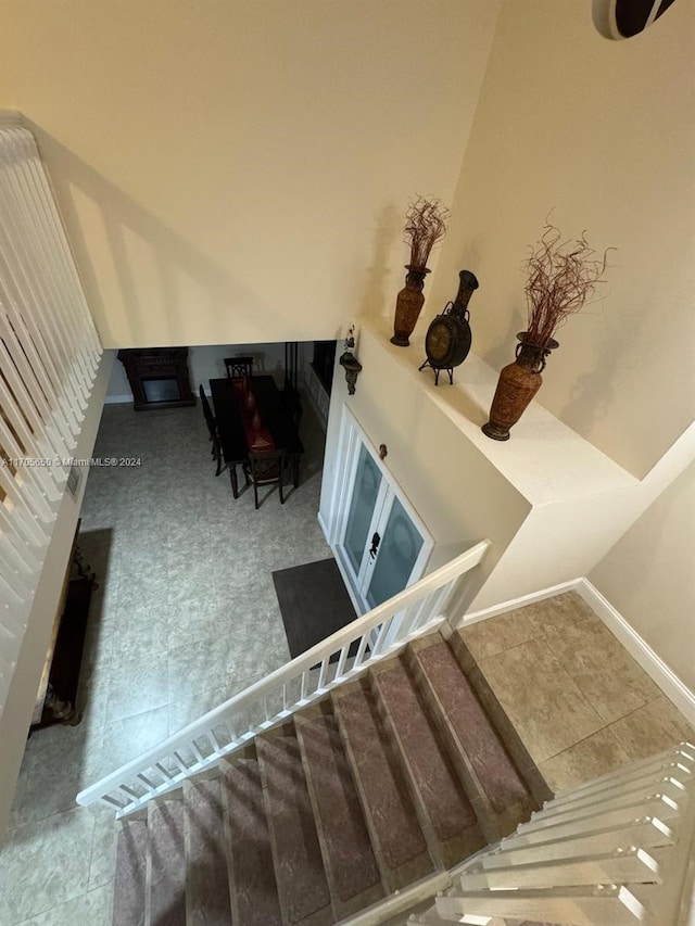 stairway featuring tile patterned flooring