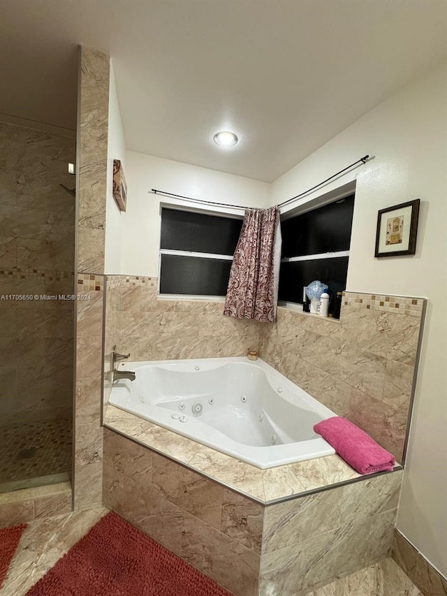 bathroom with shower with separate bathtub