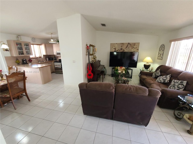 tiled living room with a wealth of natural light and sink