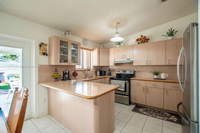 kitchen featuring kitchen peninsula, appliances with stainless steel finishes, vaulted ceiling, sink, and light brown cabinets